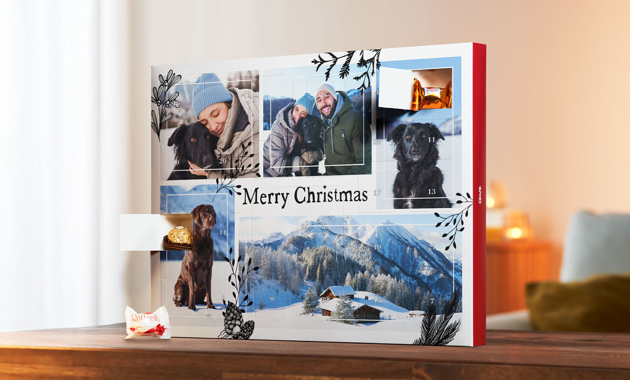 En vacker CEWE fotobok med julbilder av en hund och vinterlandskap.