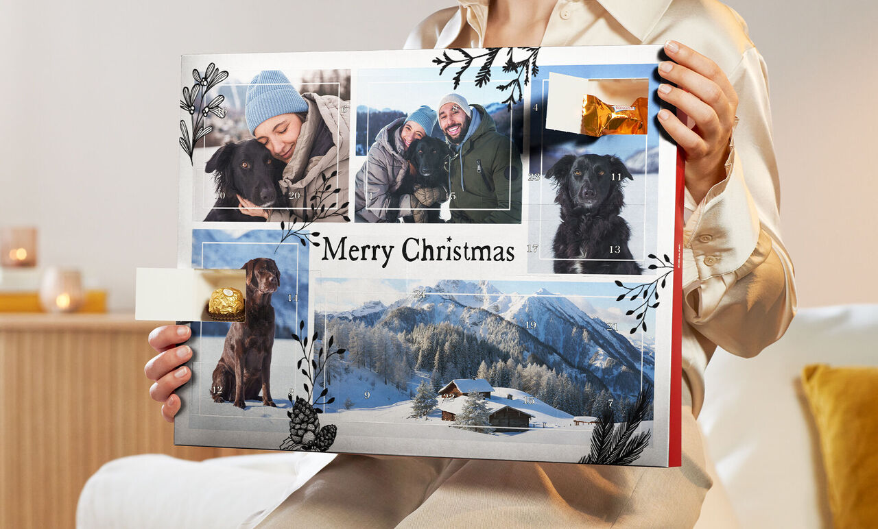 En person håller en kreativ fotobok med julmotiv i händerna.
